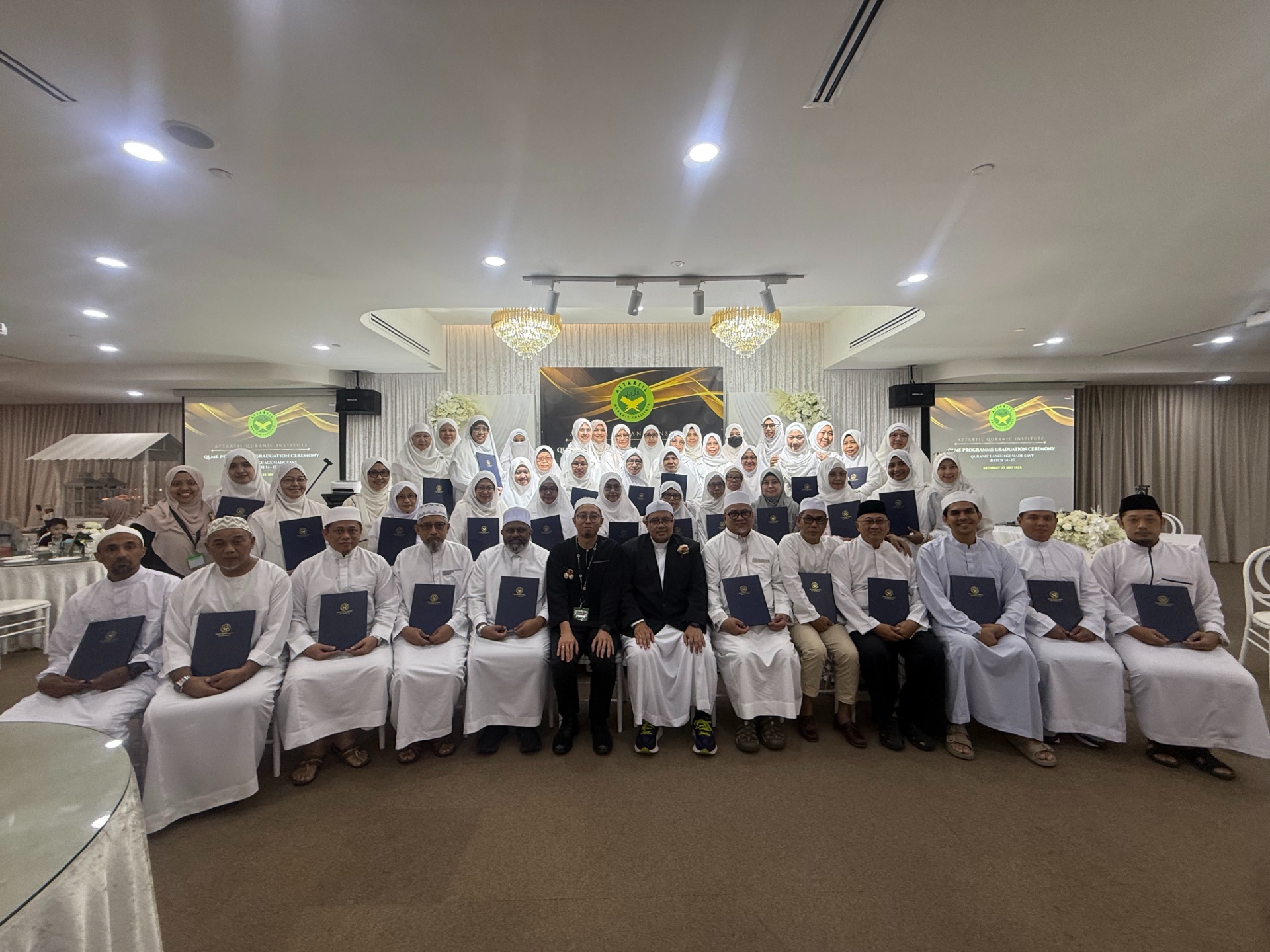 Graduating students of the QLME programme at AtTartil Quranic Institute holding their certificates during the batch 14–17 ceremony
