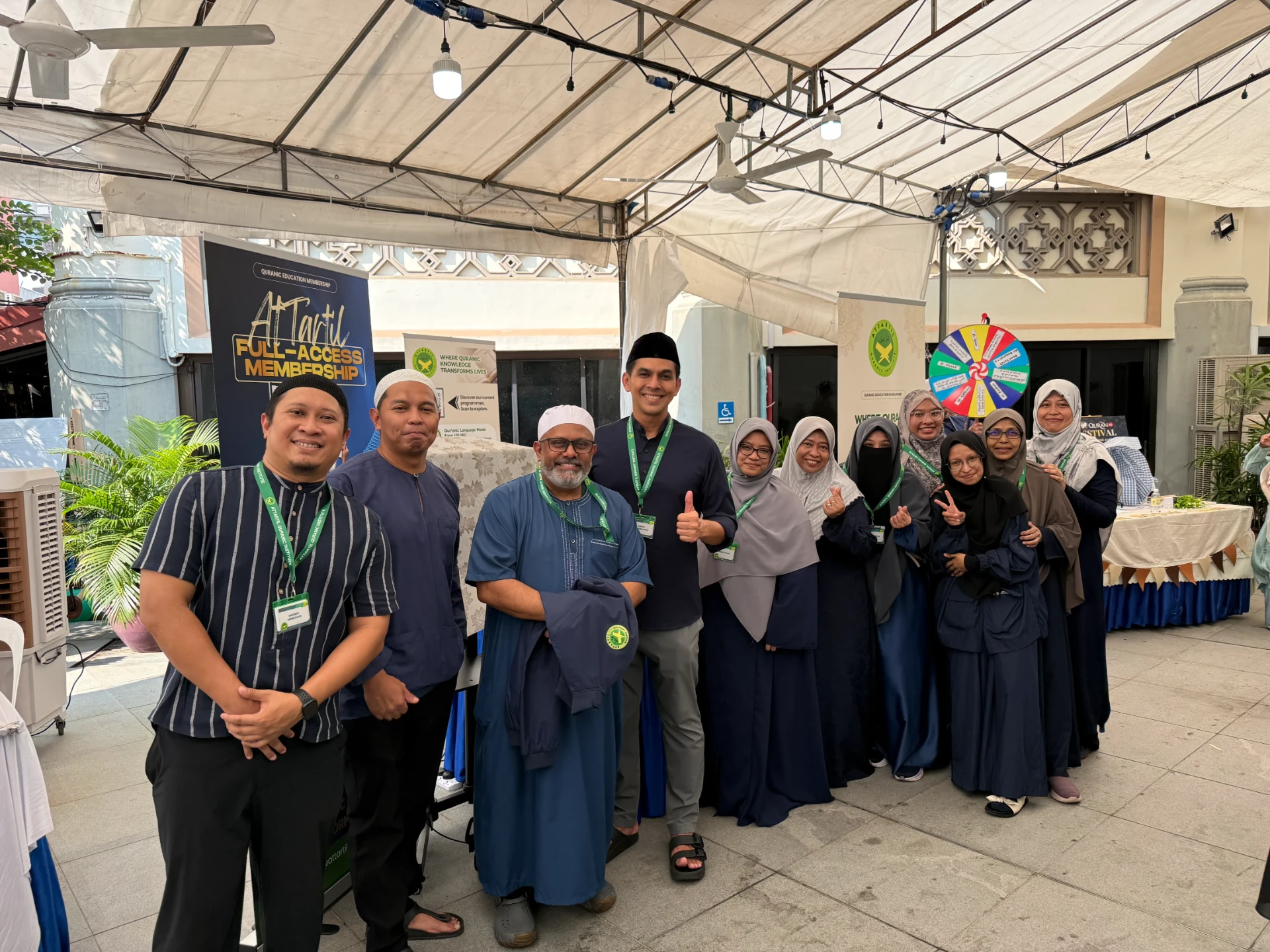 The full AtTartil QI team gathered at their Quran Festival 2026 booth