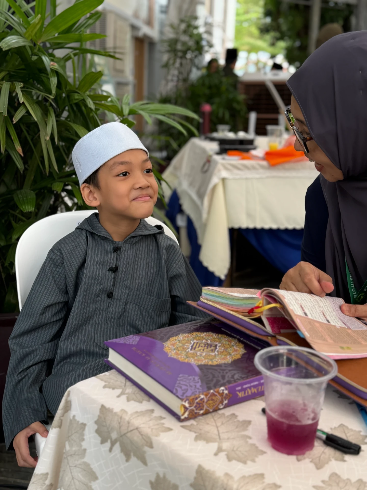 A young boy smiling during a session with an AtTartil QI teacher